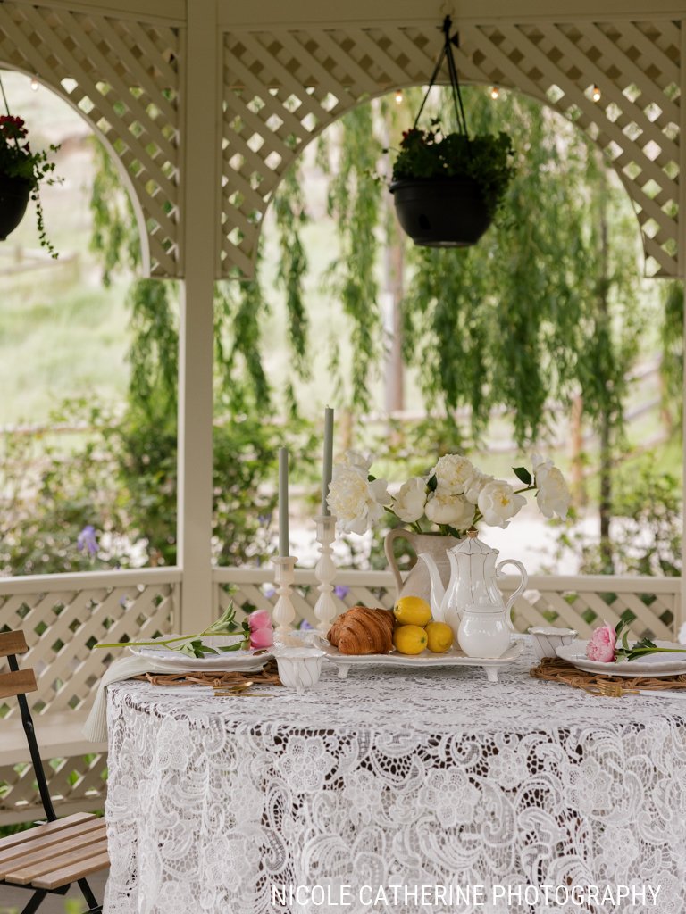 Garden gazebo set with a tea table of pastries and lemons