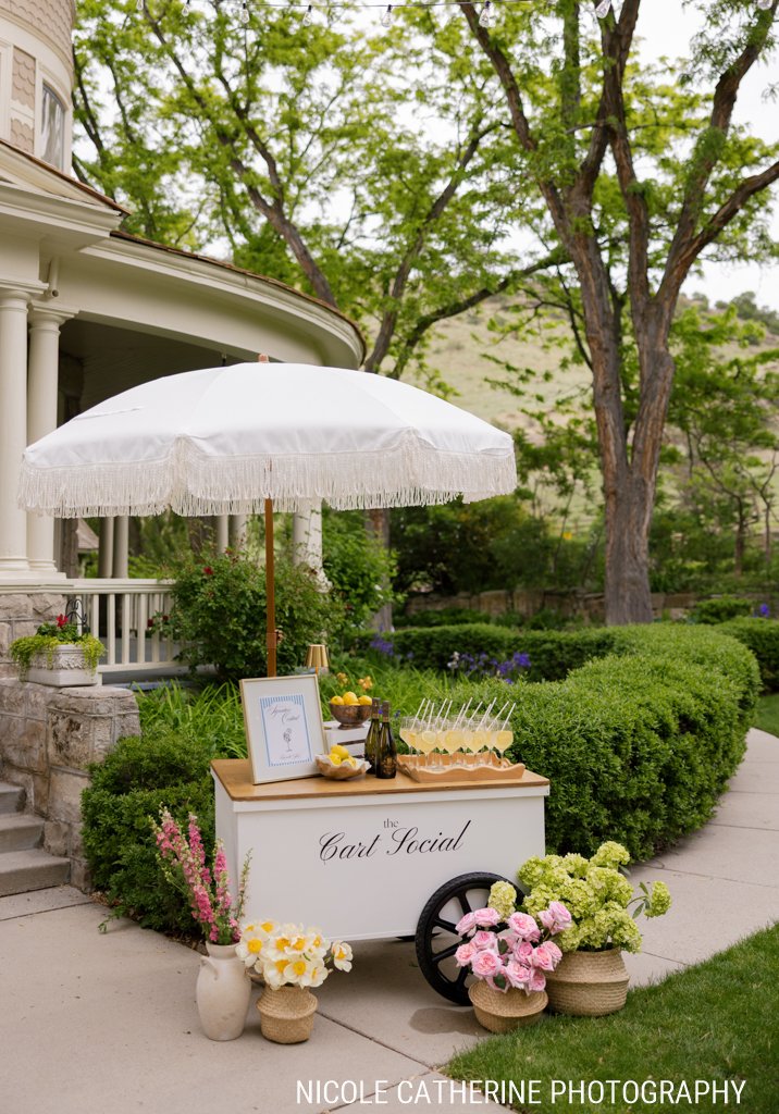 The Cart Social drink cart set up on the front walk with the house behind