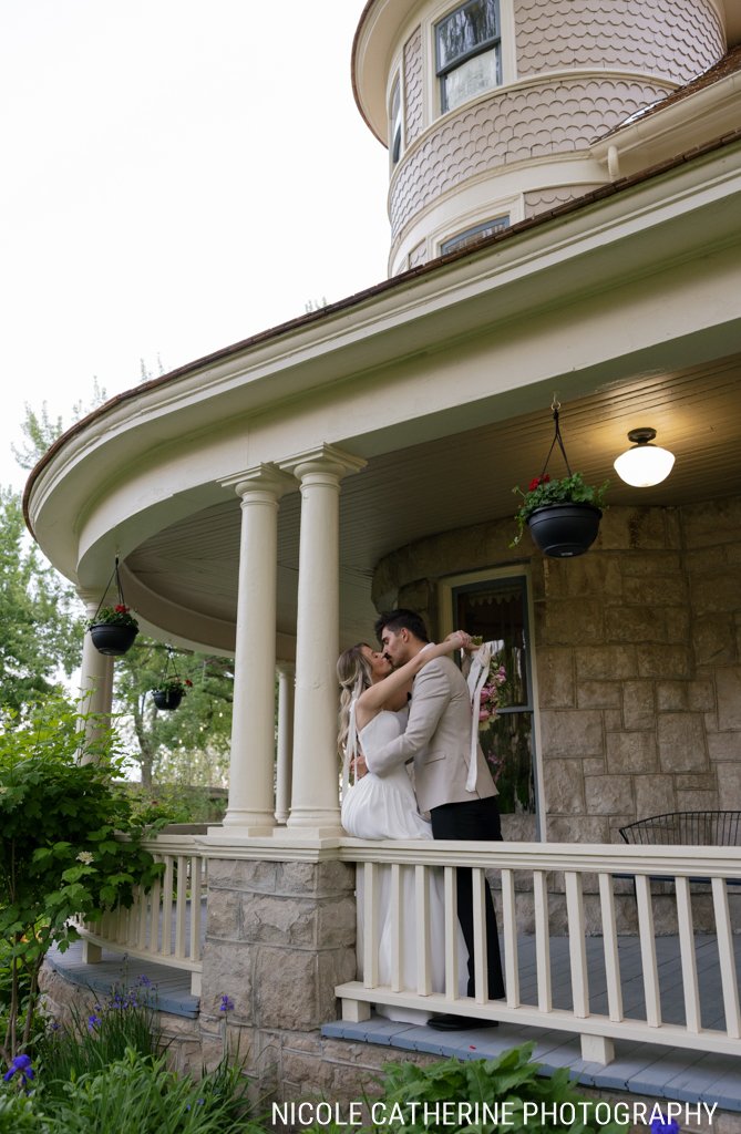 Couple sharing a kiss on the turret porch