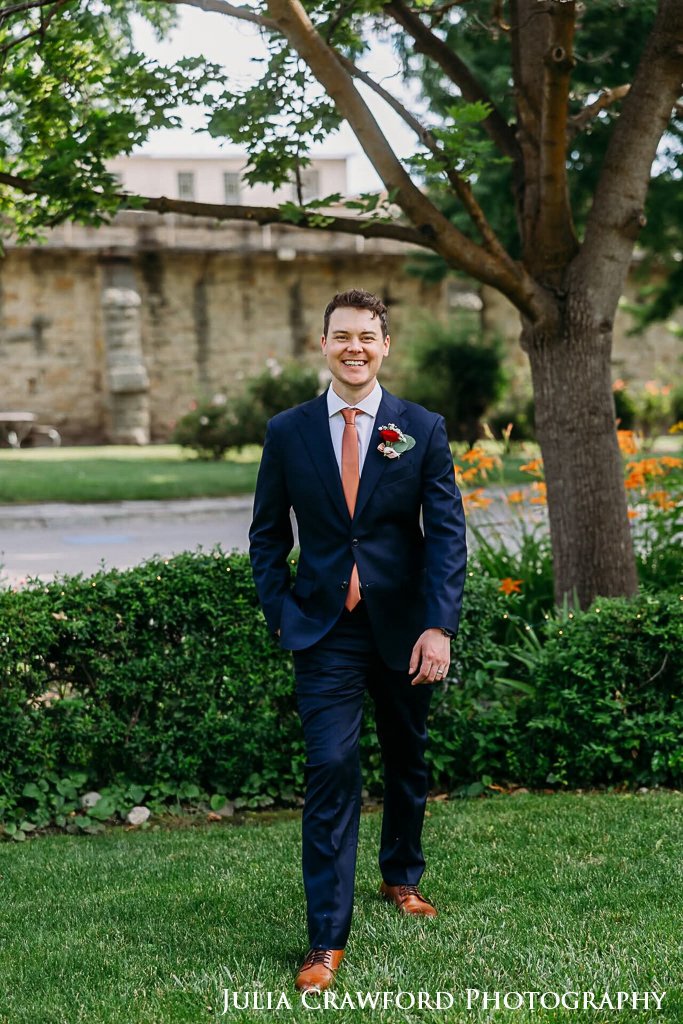Groom smiling on the grounds before the ceremony