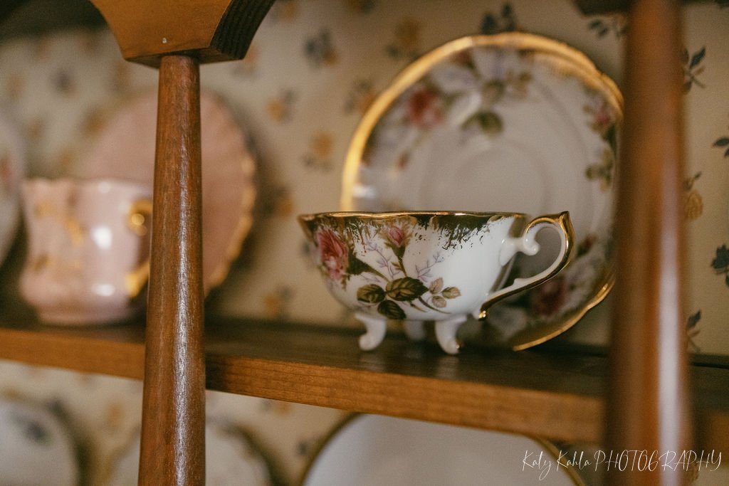 Antique teacup and saucer displayed on a shelf