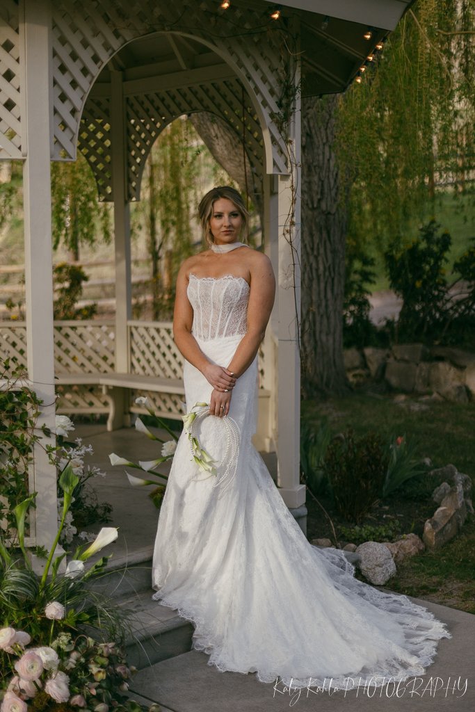 Bride posing at the garden gazebo